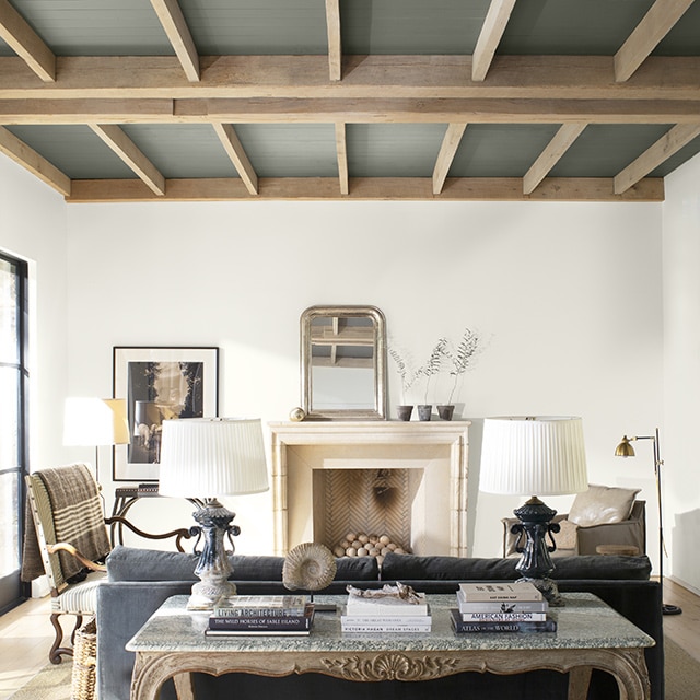 A modern neutral palette living room with high wood paneled ceiling painted in a dramatic gray. A modern neutral palette living room with high wood paneled ceiling painted in a dramatic gray.